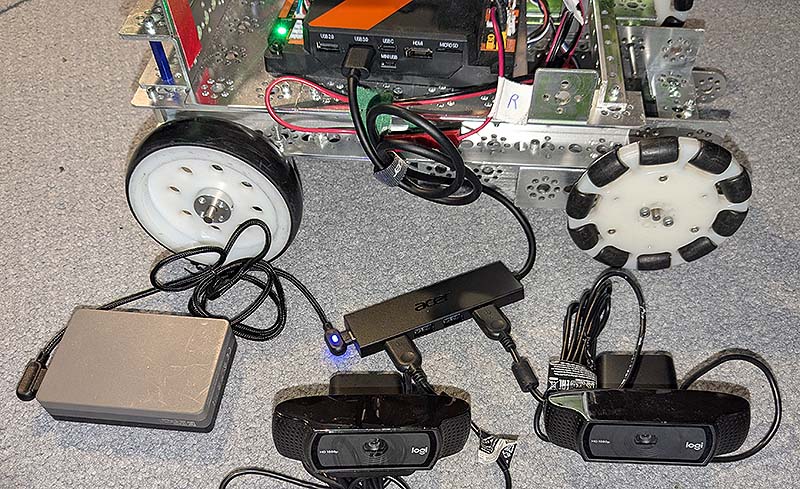 A REV Control Hub with a powered USB hub and two webcams.
